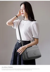 Casual nylon cross-body shoulder bag for women with multi-zipper pockets and stylish grey finish.