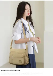 Detail view of casual nylon cross-body shoulder bag with multi-layer zipper pockets for daily use.
