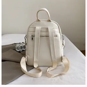 Elegant cream white PU leather women backpack detail showing adjustable straps and back zip pocket.