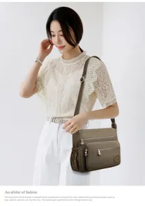 Detailed view of the multi-layer nylon crossbody bag worn by model, showcasing durable fabric.