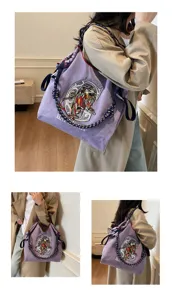 Purple canvas tote bag with embroidered lion design and thick chunky rope shoulder strap.