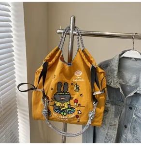 Large capacity canvas tote bag with cute cartoon rabbit embroidery, casual shoulder handbag.