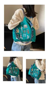 Green nylon canvas shopping tote bag with embroidered Paris landmarks and rope straps.