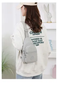 Detailed view of lightweight nylon chest bag, casual solid color sling design with zipper pocket.