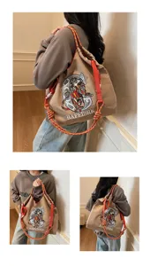 Canvas tote bag with embroidered tiger graphic, versatile shoulder and crossbody style.