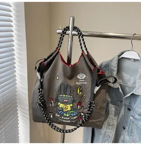 Large capacity canvas tote bag for women with cute cartoon embroidery, trendy shoulder handbag.
