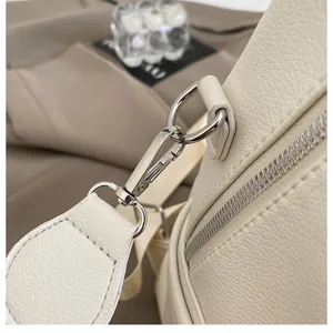 Detailed view of women's backpack hardware, metal buckle and pu leather texture close-up.
