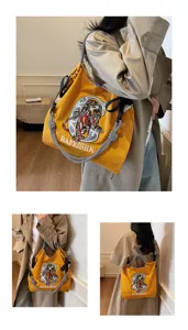 Detail shot of yellow canvas tote bag with lion embroidery and stylish woven strap for daily commute.