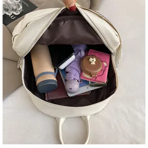 Large capacity white leather women backpack interior detail showing spacious compartment storage.