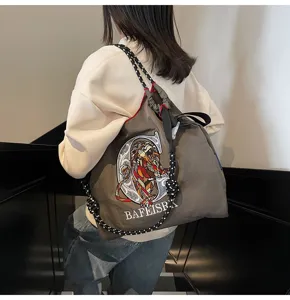Canvas crossbody tote bag featuring lion embroidery and thick drawstring straps for women