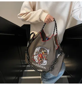 Large capacity canvas tote bag featuring lion embroidery and comfortable rope shoulder strap.
