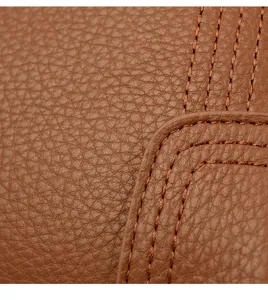 Detailed close-up shot of brown leather women handbag showcasing fine stitching and texture.
