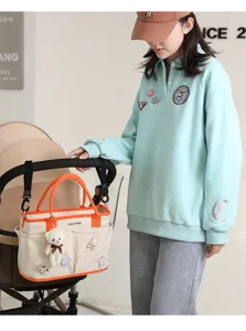 Large capacity canvas diaper bag with stroller straps and cute bear pendant for moms out.