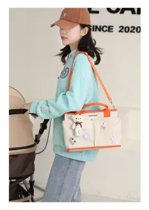 Canvas diaper bag large capacity mommy tote bag with stroller straps and cute bear pendant.