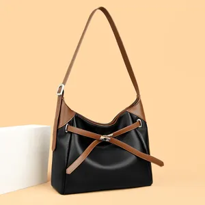 Stylish black and brown leather hobo shoulder bag with chic metal lock and elegant strap design.