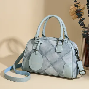 Blue denim patchwork Boston handbag for women, stylish top-handle shoulder crossbody bag.