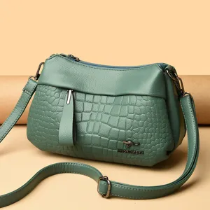 Women's green shoulder bag soft leather crossbody bag with stylish crocodile pattern and strap.