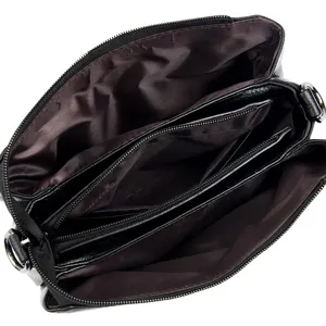 Black soft leather women's shoulder bag with multi-compartments and secure zip closure.
