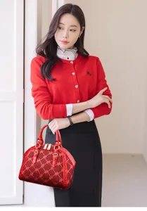 Elegant red rhinestone shell handbag with matching knit cardigan. Perfect chic commuter style.