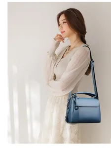 Stylish blue leather women handbag with top handle and strap, elegant commuter shoulder bag.