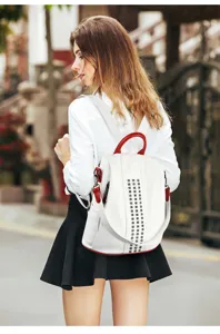 Detailed view of the stylish white and red colorblock women backpack with chic rivet details.