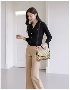 Stylish women's monogram shoulder bag with classic printed design and chic clasp.