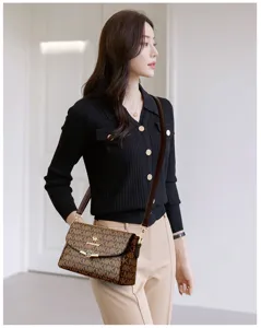 Women's brown monogram shoulder bag detail showing premium print texture and elegant metal clasp.