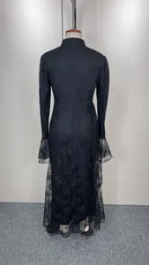 Black lace evening dress detail showing long sleeves, flare cuffs and stand collar.