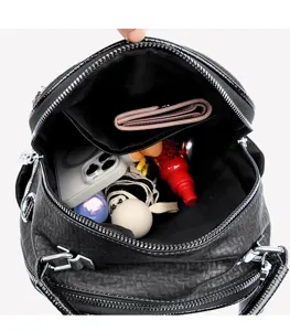 Interior detail view of black soft leather backpack showing spacious capacity and multi pockets.