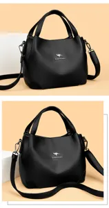 Detailed view of black soft leather women handbag with large capacity and shoulder strap.