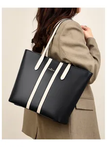 Detail view of the elegant black and white leather tote bag, showing the spacious interior.
