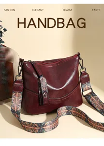 Vintage wax leather shoulder handbag with wide patterned strap, elegant daily commuting bag.
