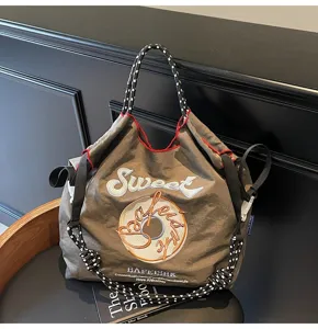 Detailed view of the Japanese style embroidered nylon tote bag with unique letter graphic design.