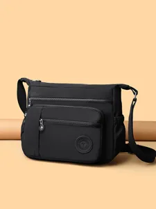 Black nylon crossbody bag for women, multi-layer shoulder bag with zipper pockets.