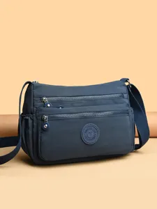 Nylon crossbody shoulder bag for women, multi-pocket casual travel messenger bag style.