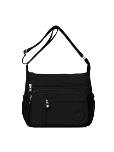 Black nylon multi-pocket crossbody bag for women, lightweight casual shoulder bag.
