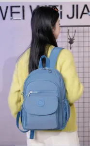 Casual blue nylon backpack for women, stylish daily travel school bag with compartments.
