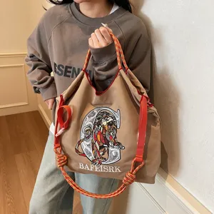 Large capacity canvas tote bag with stylish lion embroidery and adjustable strap for daily use.