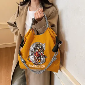 Stylish canvas tote bag with embroidered lion design, versatile crossbody shoulder bag for women.