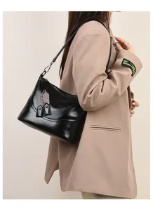 Retro women's black wax leather shoulder bucket bag, chic commuting crossbody with strap.