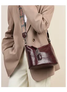 Retro cow leather shoulder bag for women with ethnic wide strap fashion commuting crossbody bag.