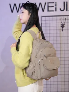 Casual nylon backpack for women, multi-pocket school bag, light beige daypack.
