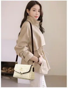 Detailed view of stylish monogram crossbody bag showcasing its chic pattern and elegant design.