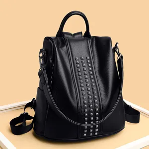 Stylish black leather anti-theft backpack for women with vertical rivet decoration.