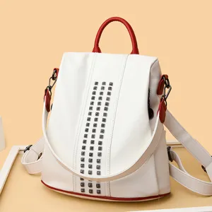 Fashion women's color-block backpack with metal studs, anti-theft casual travel daypack.