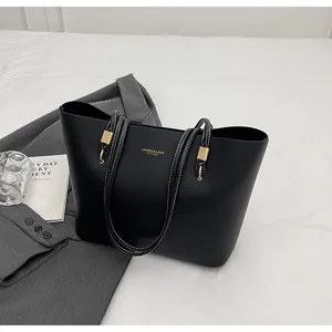 Elegant black large-capacity tote bag detail, featuring minimalist design and chic metal accents.