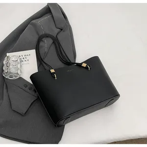 Detail view of the black minimalist large capacity tote bag, PU leather shoulder bag commute.