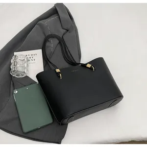 Black minimalist tote bag with slim straps, elegant daily commuter handbag and shoulder bag.