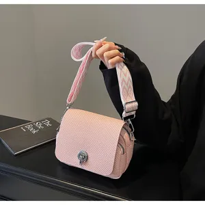Detailed view of women pink woven crossbody bag with wide strap and twist lock design.