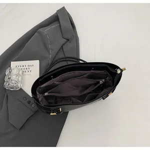Detailed view of black minimalist tote bag interior with multiple compartments and secure zipper.